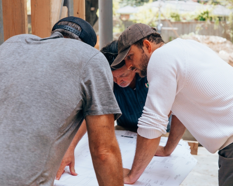 Builders and client working together on home extension project
