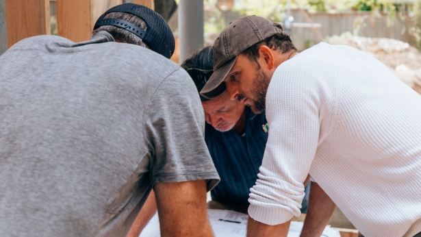 Builders and client working together on home extension project